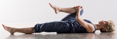 Women on back with one leg to chest